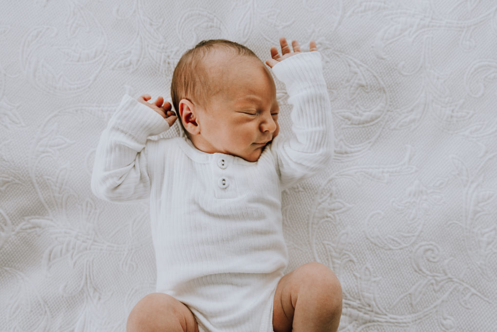 classic white photo of baby boy in white linen