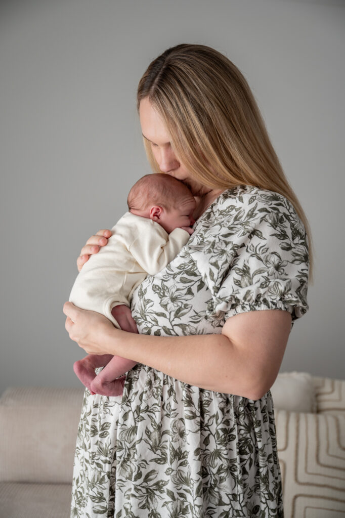 a swaying mum kissing her babies head