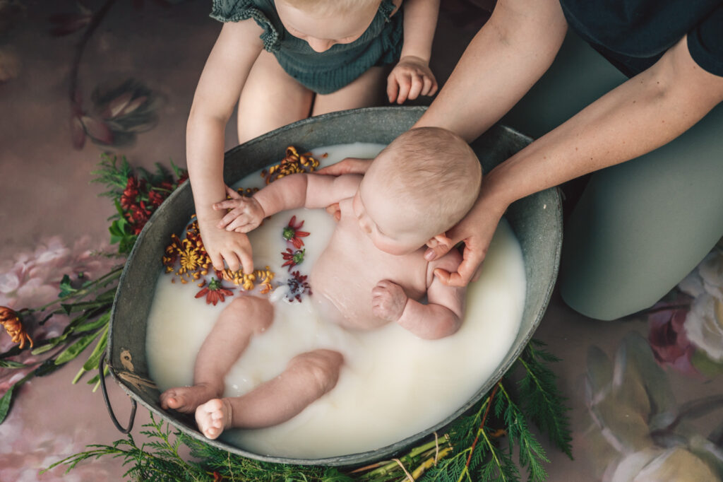 sisters playing in a milk bath session
