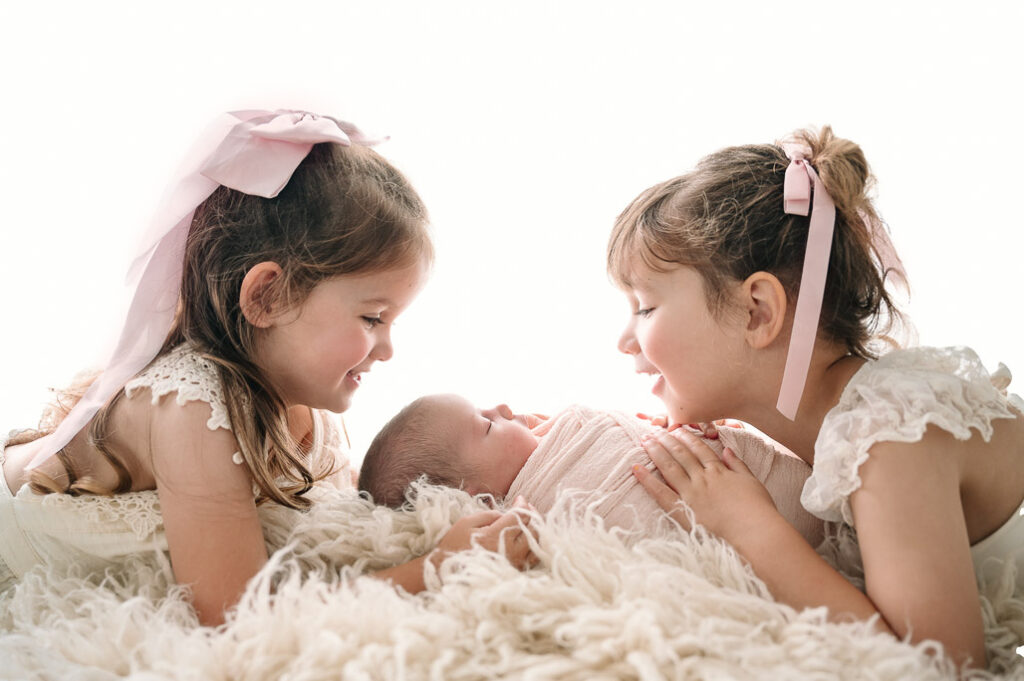 beautiful sisters on a cozy white rug