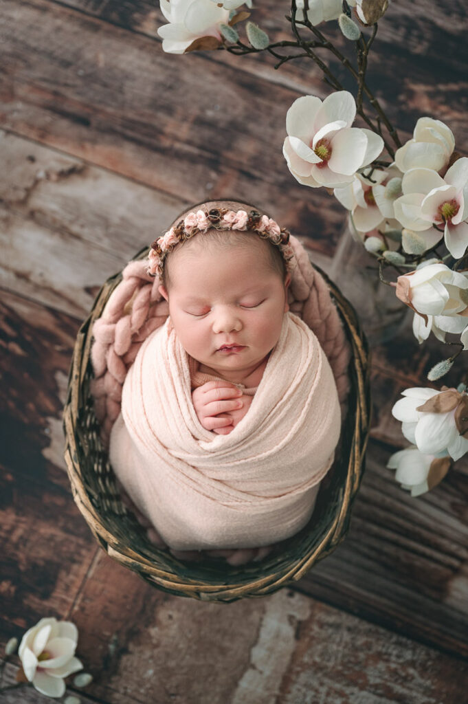 Baby girl in a cane basket