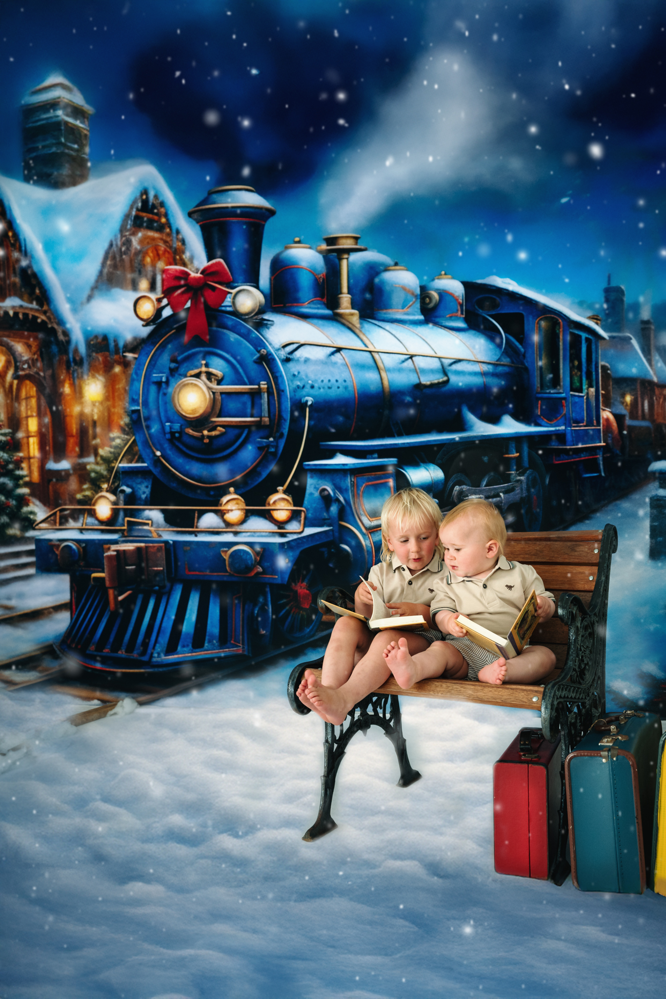 2 little brothers on a park bench infront of a large christms train backdrop.
